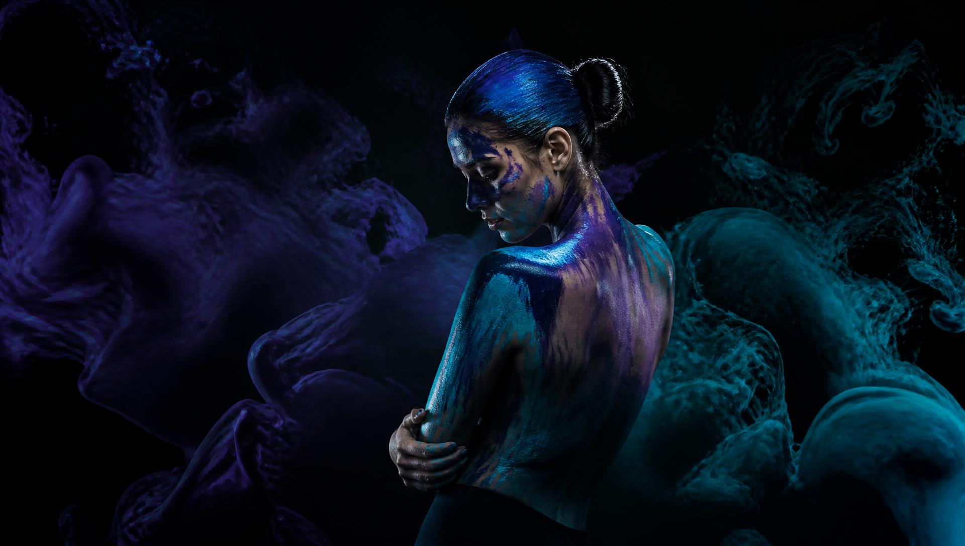 Abstract painted portrait in purple and cyan light